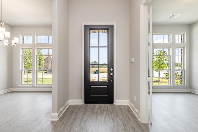 entrance foyer featuring wood finished floors, visible vents, and baseboards