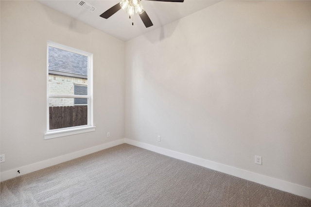 empty room with carpet flooring, visible vents, and baseboards