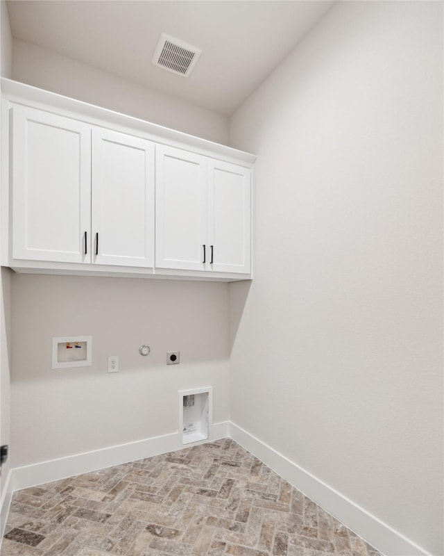 laundry room featuring hookup for a washing machine, cabinet space, visible vents, hookup for an electric dryer, and baseboards