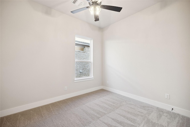 unfurnished room featuring carpet floors, visible vents, baseboards, and a ceiling fan