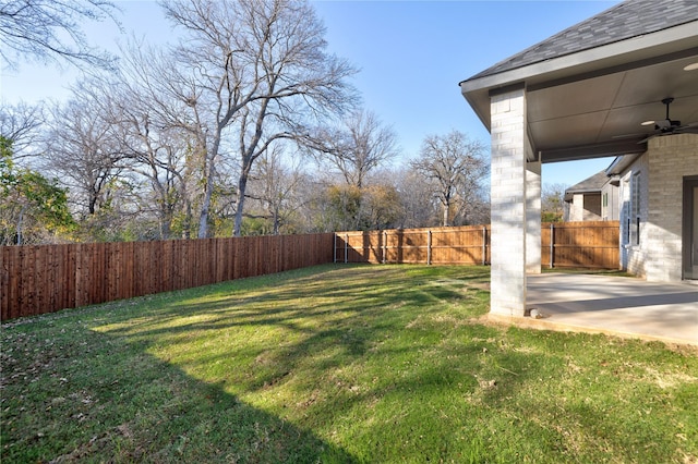 view of yard featuring a fenced backyard, ceiling fan, and a patio