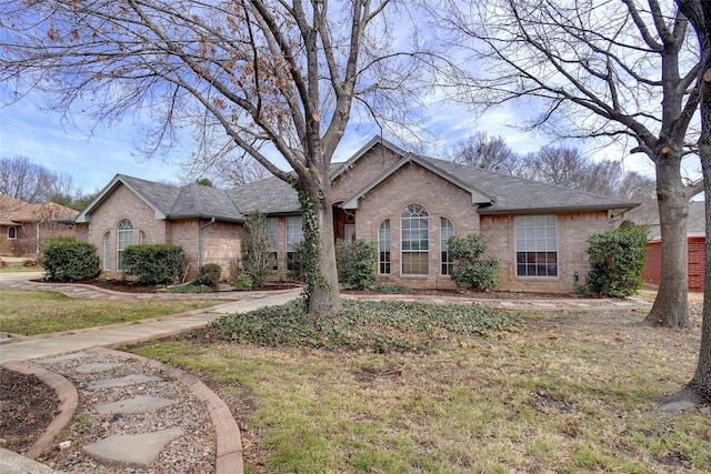 ranch-style house featuring brick siding