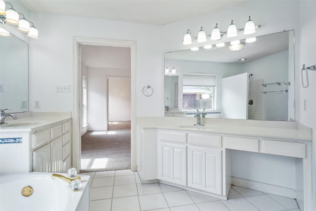 bathroom featuring two vanities, a sink, and a bathing tub