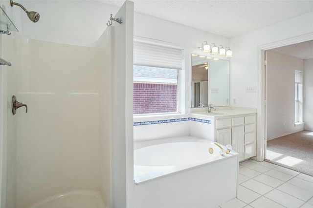 bathroom with a garden tub, tile patterned flooring, a shower, and a textured ceiling