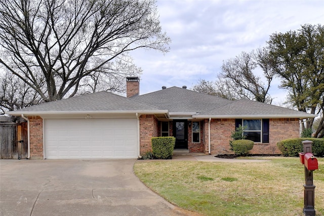 ranch-style house with a garage, brick siding, a chimney, and a front yard