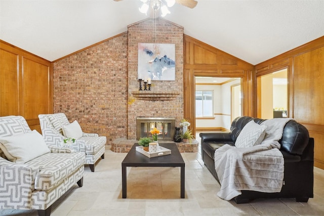 living room with brick wall, a fireplace, wood walls, lofted ceiling, and ceiling fan