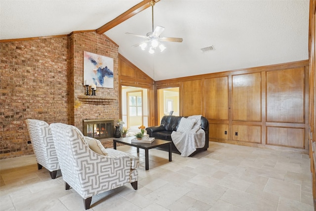 living area featuring brick wall, wood walls, visible vents, a brick fireplace, and beamed ceiling