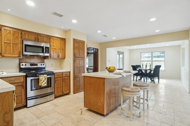 kitchen with stone tile floors, visible vents, recessed lighting, and appliances with stainless steel finishes