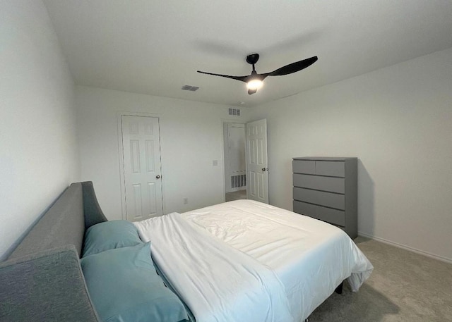 bedroom with baseboards, visible vents, a ceiling fan, and light colored carpet