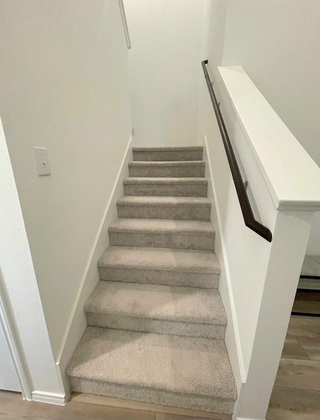 stairway featuring wood finished floors