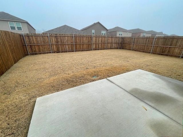 view of yard featuring a patio and a fenced backyard