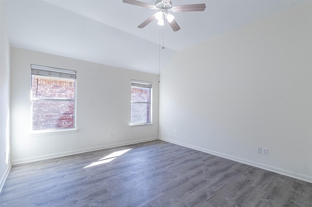 spare room with lofted ceiling, ceiling fan, baseboards, and wood finished floors