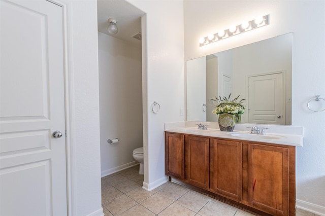 full bath with tile patterned flooring, a sink, toilet, and double vanity