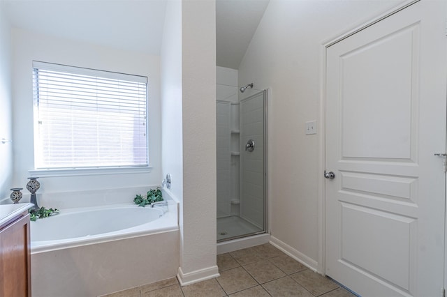 full bathroom with baseboards, tile patterned floors, vanity, a shower stall, and a bath