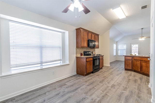 kitchen featuring black appliances, brown cabinetry, and visible vents