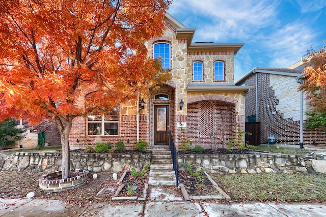 view of front of property with stone siding and brick siding