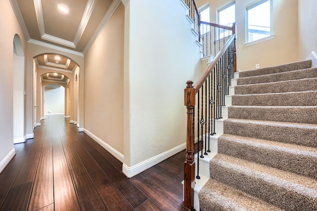 interior space with arched walkways, dark wood-style flooring, crown molding, and baseboards