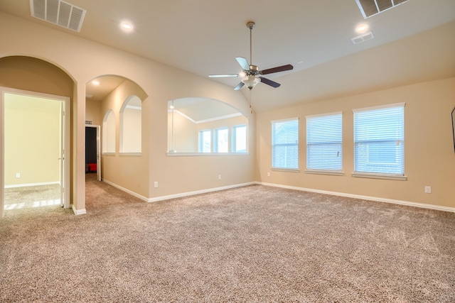 carpeted empty room with baseboards, visible vents, and recessed lighting