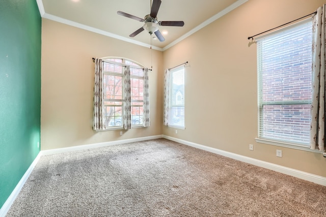 unfurnished room with ceiling fan, ornamental molding, carpet flooring, and baseboards