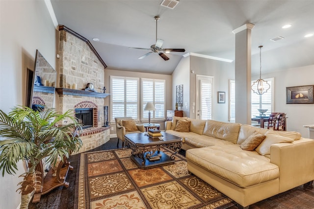 living room with lofted ceiling, visible vents, a fireplace, and ceiling fan with notable chandelier