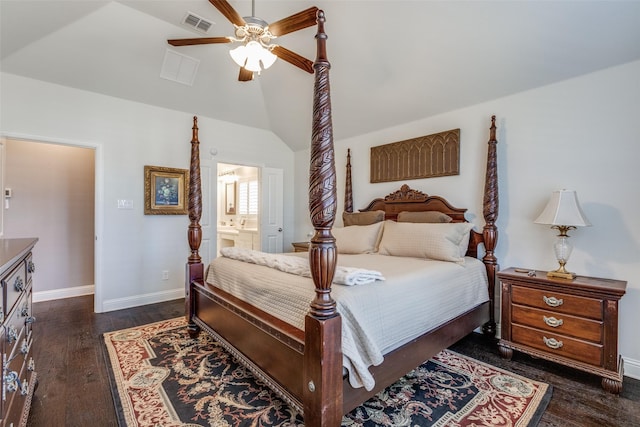 bedroom featuring dark wood finished floors, lofted ceiling, visible vents, ensuite bathroom, and baseboards