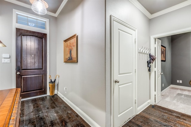 foyer with baseboards, ornamental molding, and dark wood-style flooring