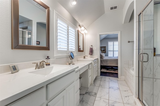 ensuite bathroom featuring marble finish floor, visible vents, vaulted ceiling, a sink, and a shower stall