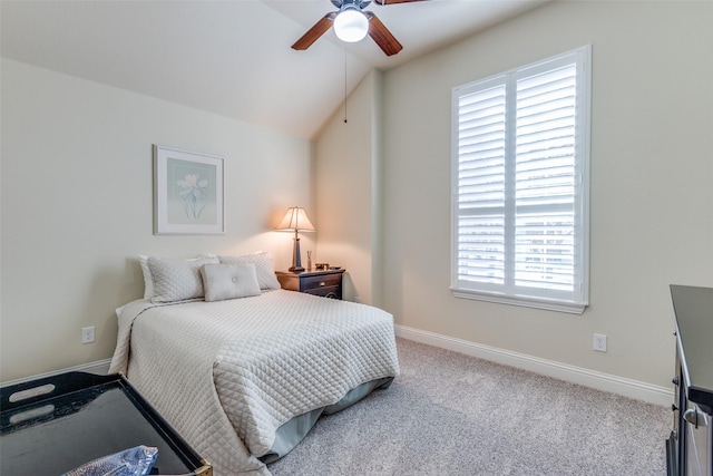 carpeted bedroom featuring lofted ceiling and baseboards