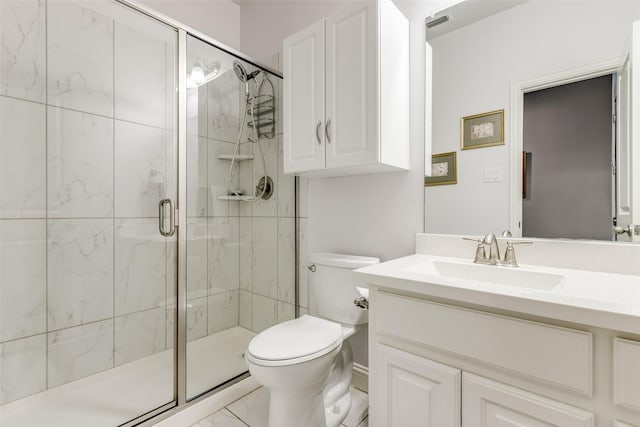 full bathroom featuring marble finish floor, a stall shower, vanity, and toilet