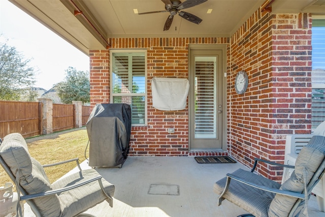 view of patio / terrace featuring fence, grilling area, and a ceiling fan