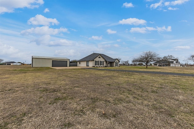 view of yard featuring a garage and an outdoor structure