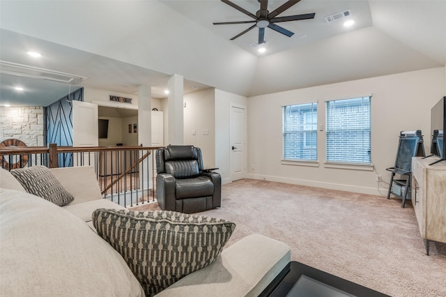 carpeted living area featuring attic access, visible vents, baseboards, lofted ceiling, and ceiling fan