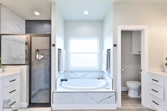 bathroom with vanity, a shower stall, and a bath