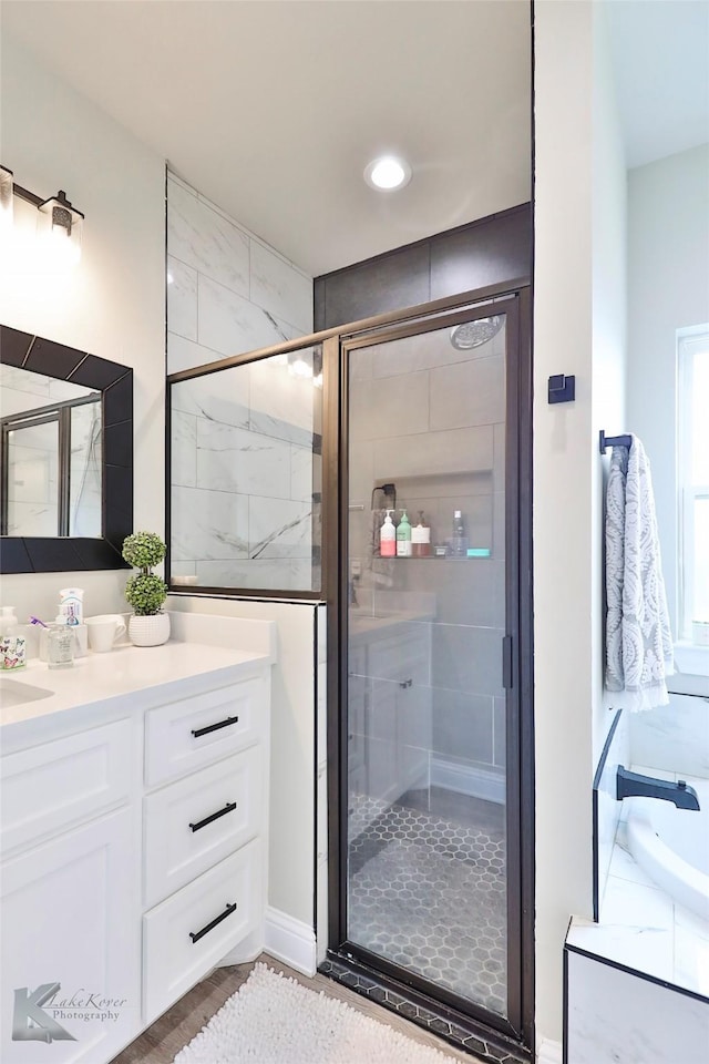 bathroom with a stall shower and vanity