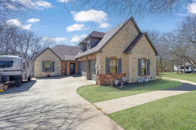 view of home's exterior featuring driveway, a yard, a garage, stone siding, and brick siding