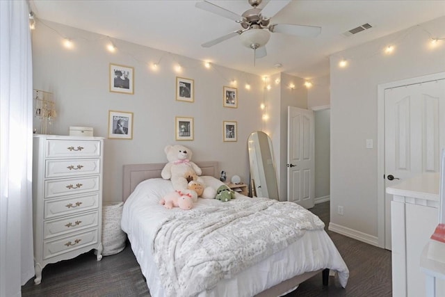 bedroom with visible vents, baseboards, dark wood finished floors, arched walkways, and a ceiling fan