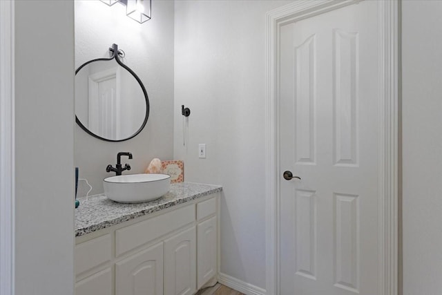 bathroom featuring baseboards and vanity