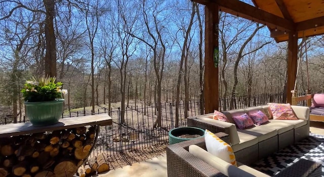 view of patio featuring outdoor lounge area and fence