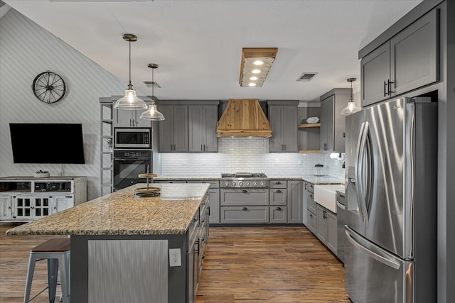 kitchen with visible vents, appliances with stainless steel finishes, custom exhaust hood, gray cabinetry, and open shelves