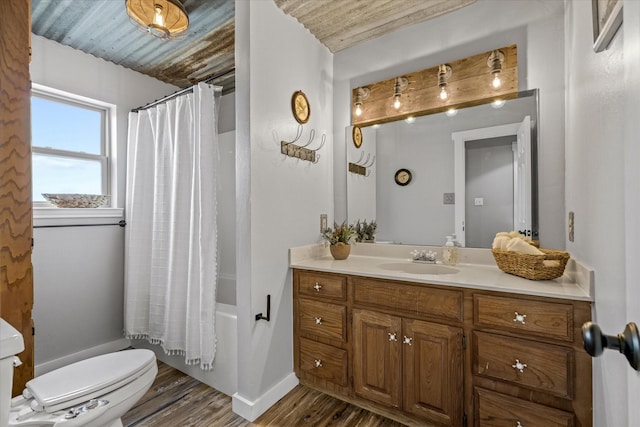 full bath with toilet, wood finished floors, vanity, baseboards, and shower / bathtub combination with curtain