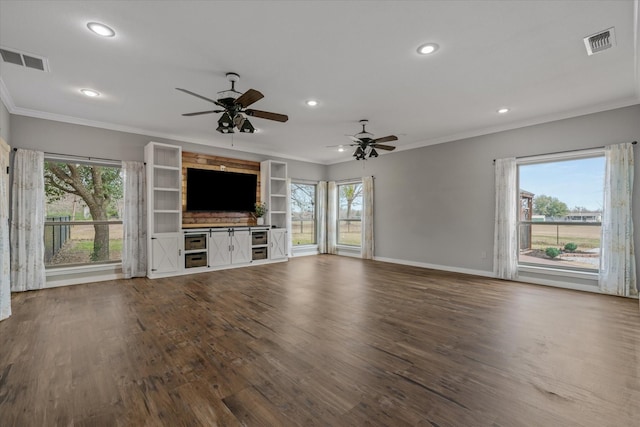 unfurnished living room featuring visible vents, crown molding, and wood finished floors