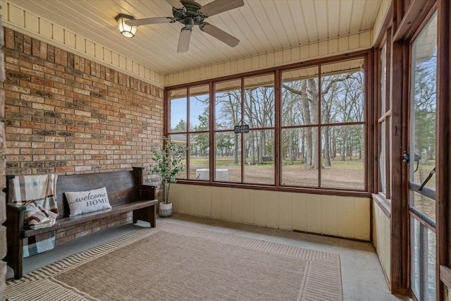 unfurnished sunroom featuring a ceiling fan