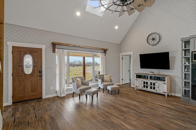 entrance foyer with high vaulted ceiling, a skylight, wood finished floors, a ceiling fan, and baseboards