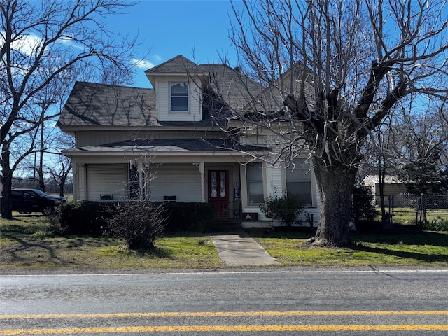 view of front of property with fence and a porch