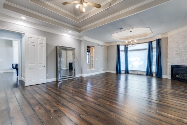 unfurnished living room featuring a tray ceiling, hardwood / wood-style flooring, and visible vents