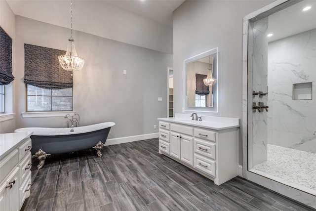 bathroom with wood tiled floor, a marble finish shower, vanity, and baseboards