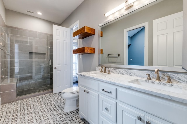 full bathroom with visible vents, a stall shower, a sink, and toilet