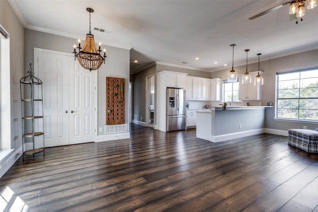 kitchen with open floor plan, visible vents, stainless steel fridge with ice dispenser, and white cabinetry