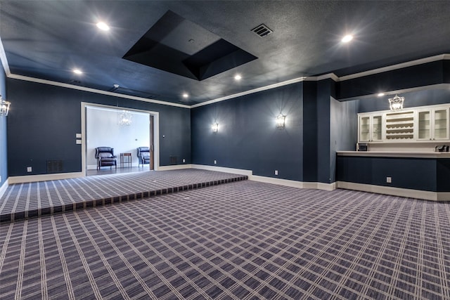 cinema with carpet, visible vents, crown molding, and baseboards