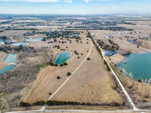 birds eye view of property featuring a water view and a rural view